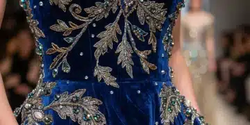 Intricate hand-embroidery on a haute couture garment, detailing metallic threads and beadwork.
